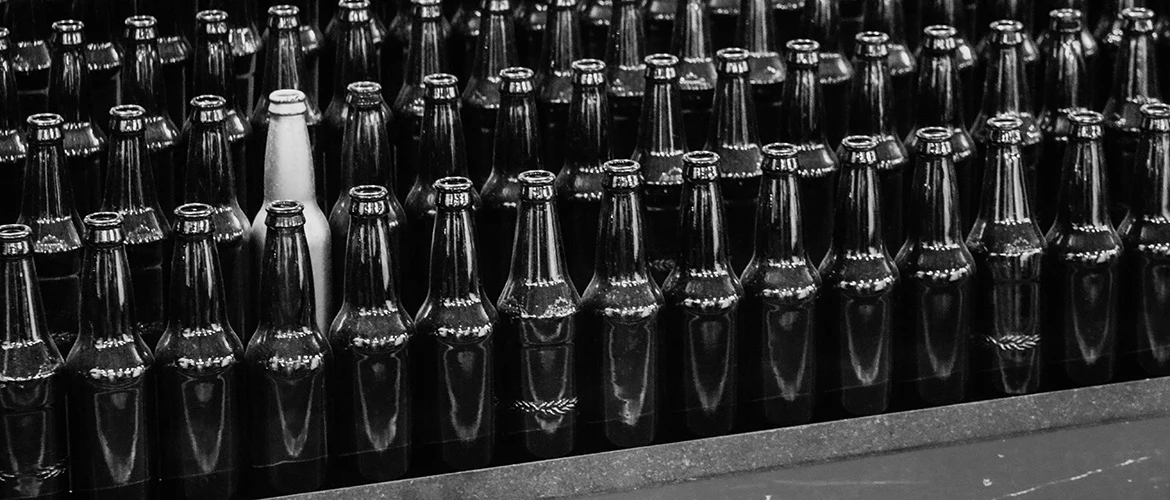 white bottle among black bottles - image by Will Myers via Unsplash